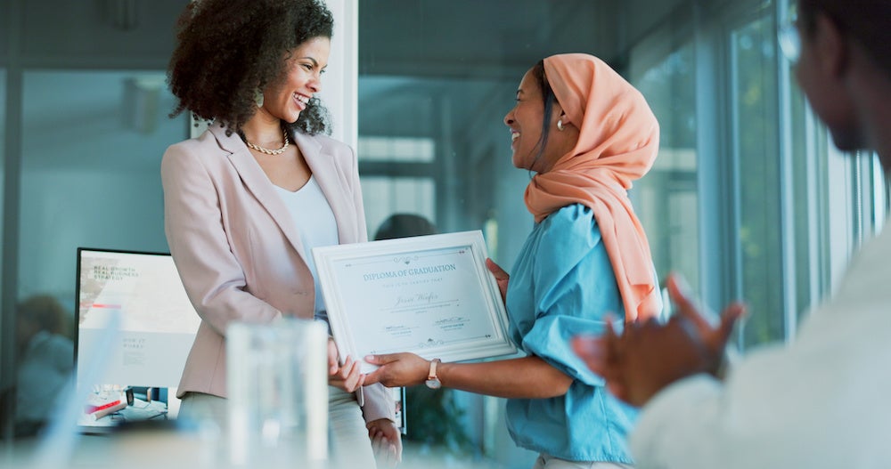 Award, winner and applause with a business black woman and team in celebration of the achievement of a male colleague. Thank you, meeting and support with a Muslim african american women being awarde.