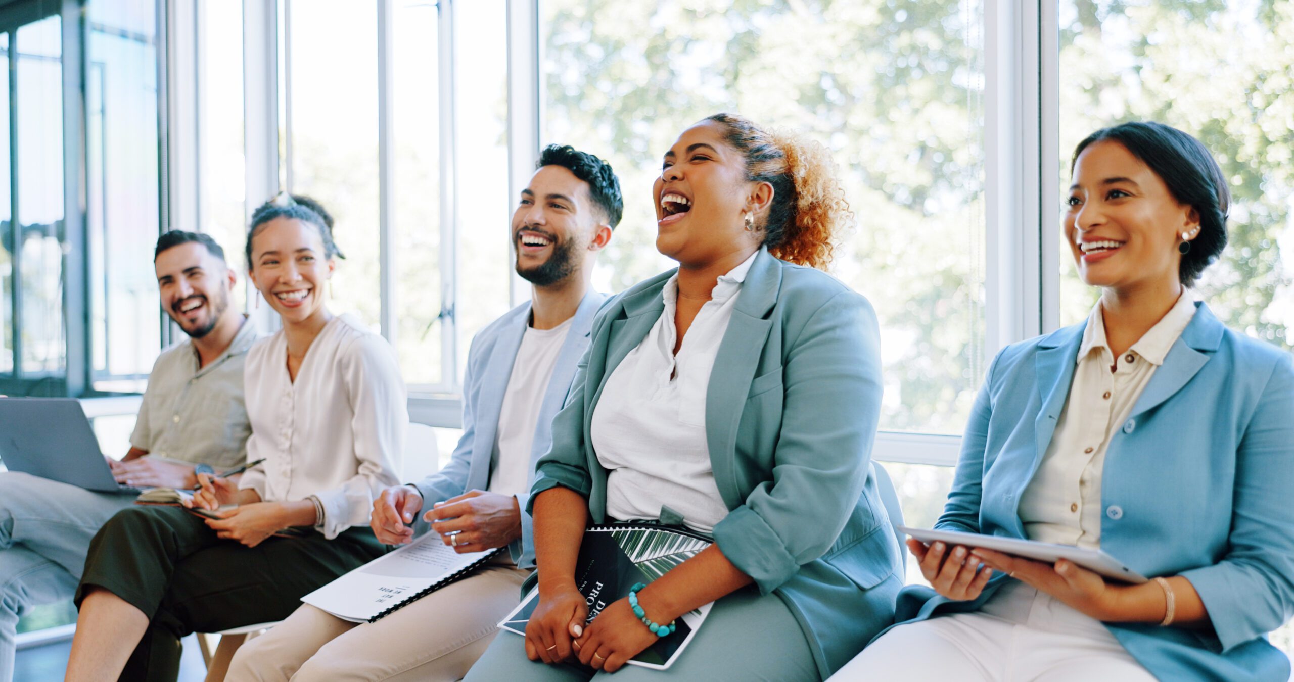 happy employees sitting together and laughing