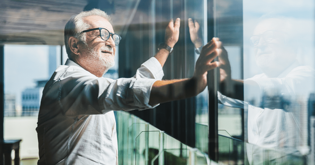 retiring man looking out office window