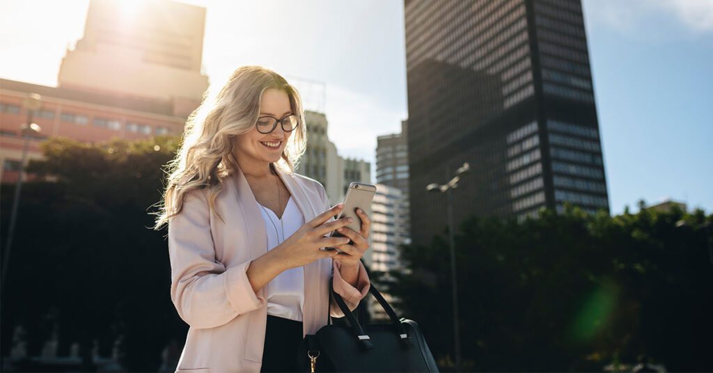 empowered employee checking phone while walking