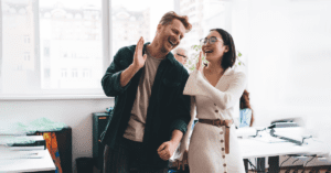 man and woman in office high fiving