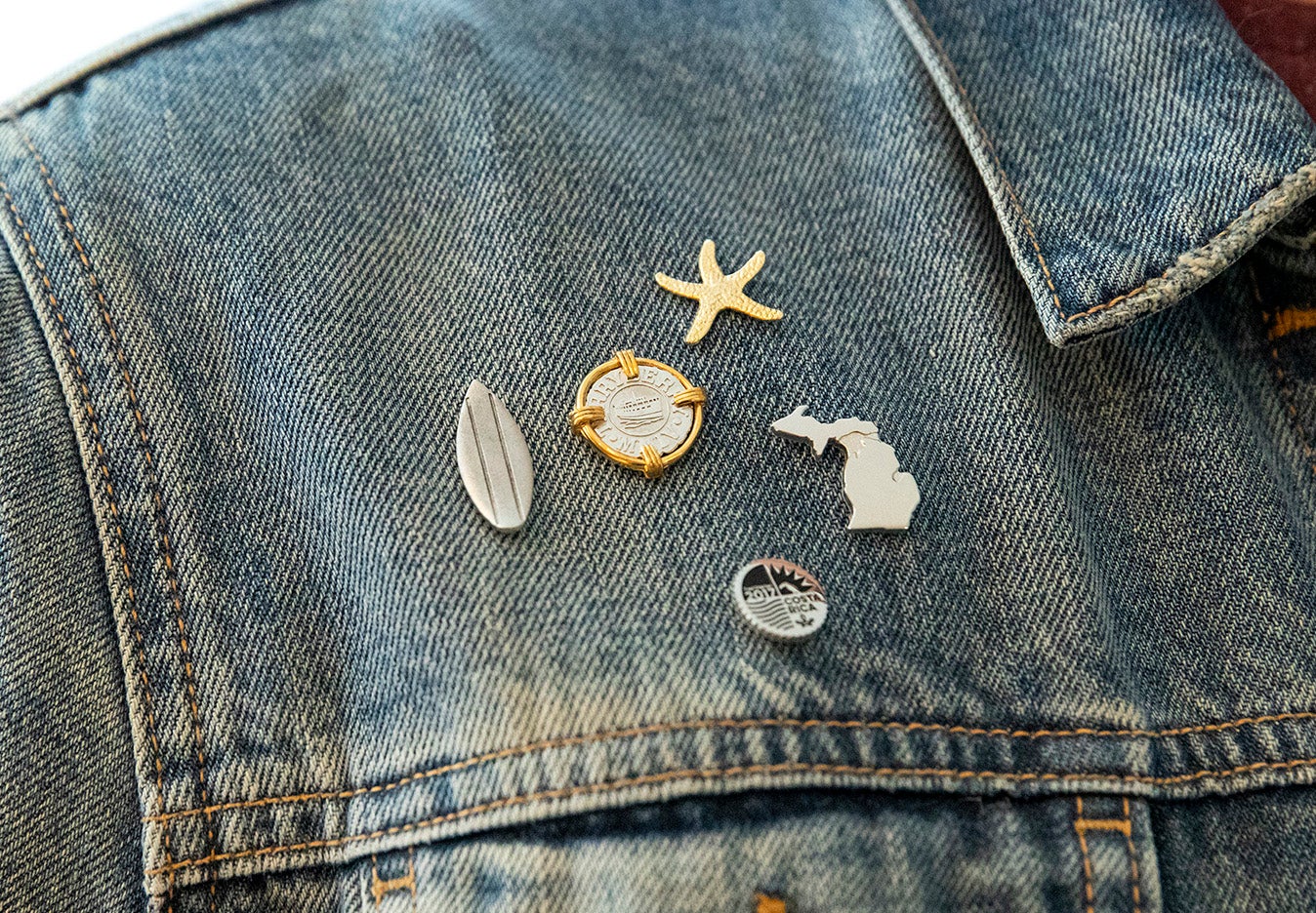 Young man wearing a blue jacket with lapel pins attached