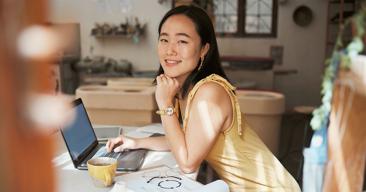 happy woman at home desk