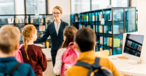 librarian working with kids in library